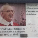 S. Giovanni, Bacheca esterna, lato Nord. Targa Commemorativa di Don D. Oggero, ex-Parroco di S. Giovanni